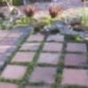 A garden enhanced by paving, tiling and cobbles.